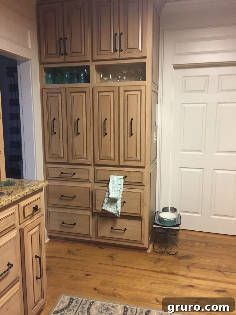 Kitchen before cabinets were painted, showing original dark look
