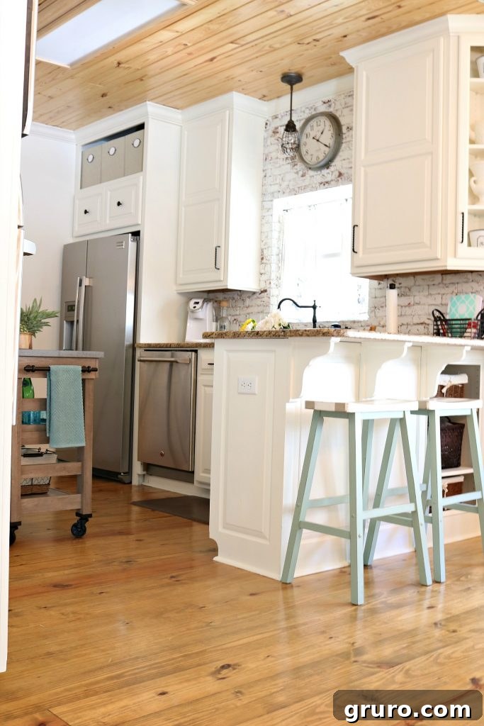 Kitchen painted Sherwin Williams Dover White for both brick and cabinets