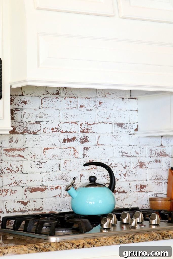 Distressed real bricks painted white behind the cooktop