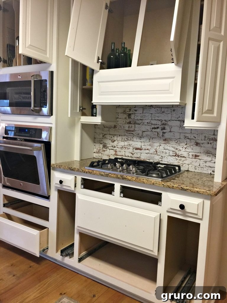 Kitchen makeover with freshly painted cabinets and brick