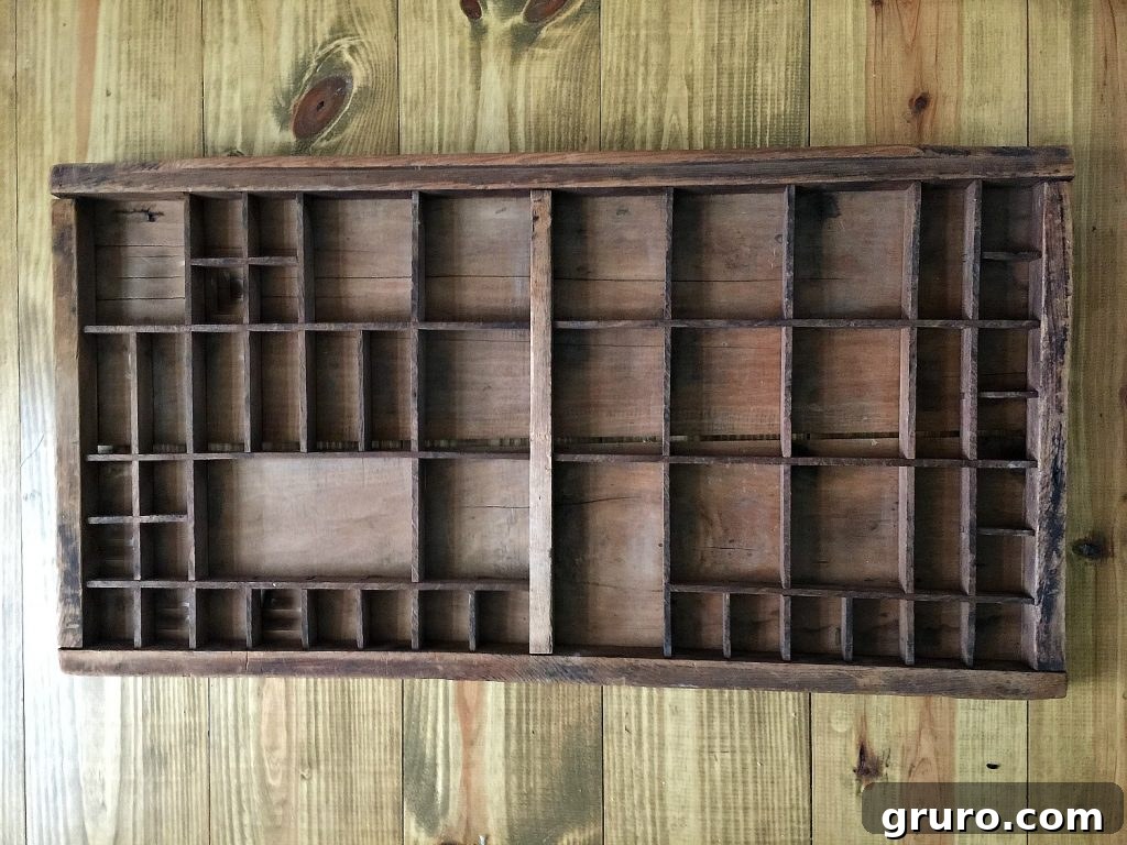 Old printers tray repurposed into a unique and charming Advent calendar, highlighting its original rustic appeal.