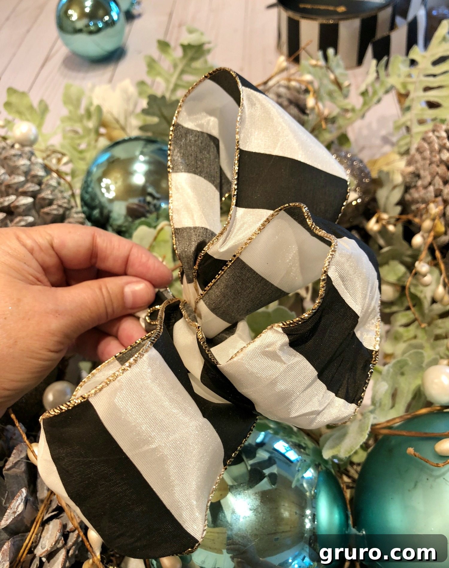 Christmas Wreath Glow-Up 7 Adding a black and white wired ribbon to the Christmas wreath for contrast and elegance
