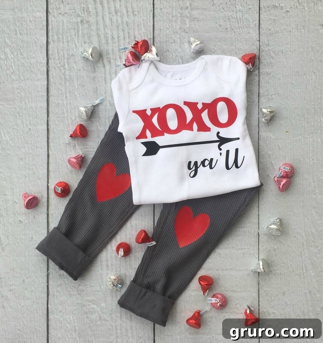 Romantic Valentine's Day Styles 3 Close-up of a baby's onesie with glittery XOXO y'all heat transfer vinyl design
