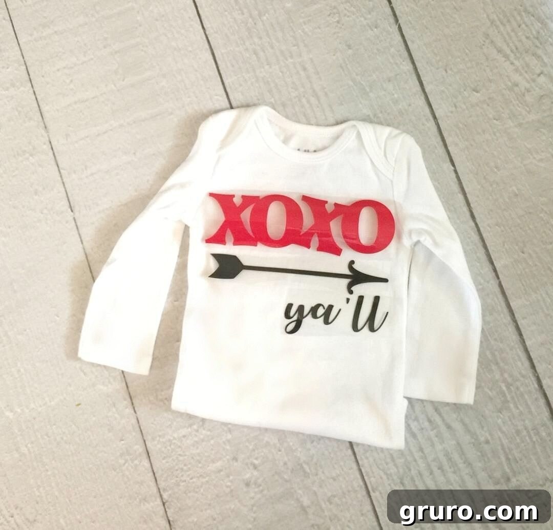 Romantic Valentine's Day Styles 7 Carefully positioning the XOXO y'all vinyl design onto a plain white onesie