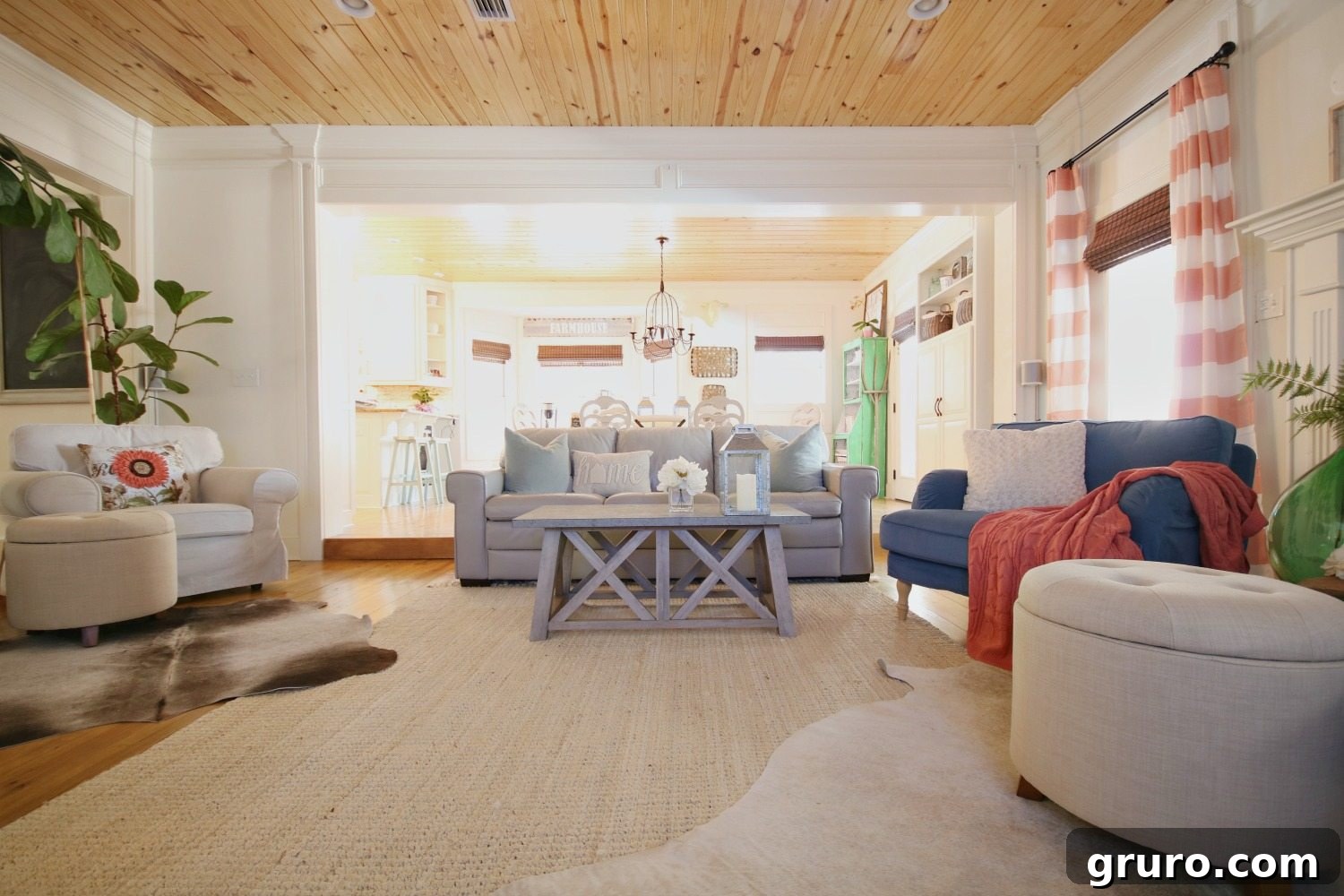 Thoughtful layout for a family room, featuring a farmhouse coffee table and a gallery wall with a television, a painted fireplace, and colorful accents in an eclectic farmhouse style. Sponsored by Better Homes & Gardens at Walmart.
