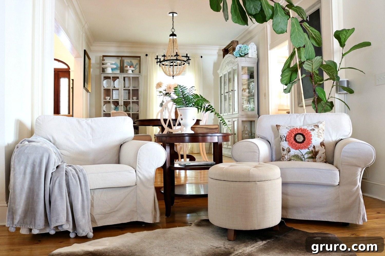 A charming conversation area with two chairs, complemented by a perfect storage ottoman and a lush fiddle leaf fig tree. Featured products from Better Homes & Gardens at Walmart.