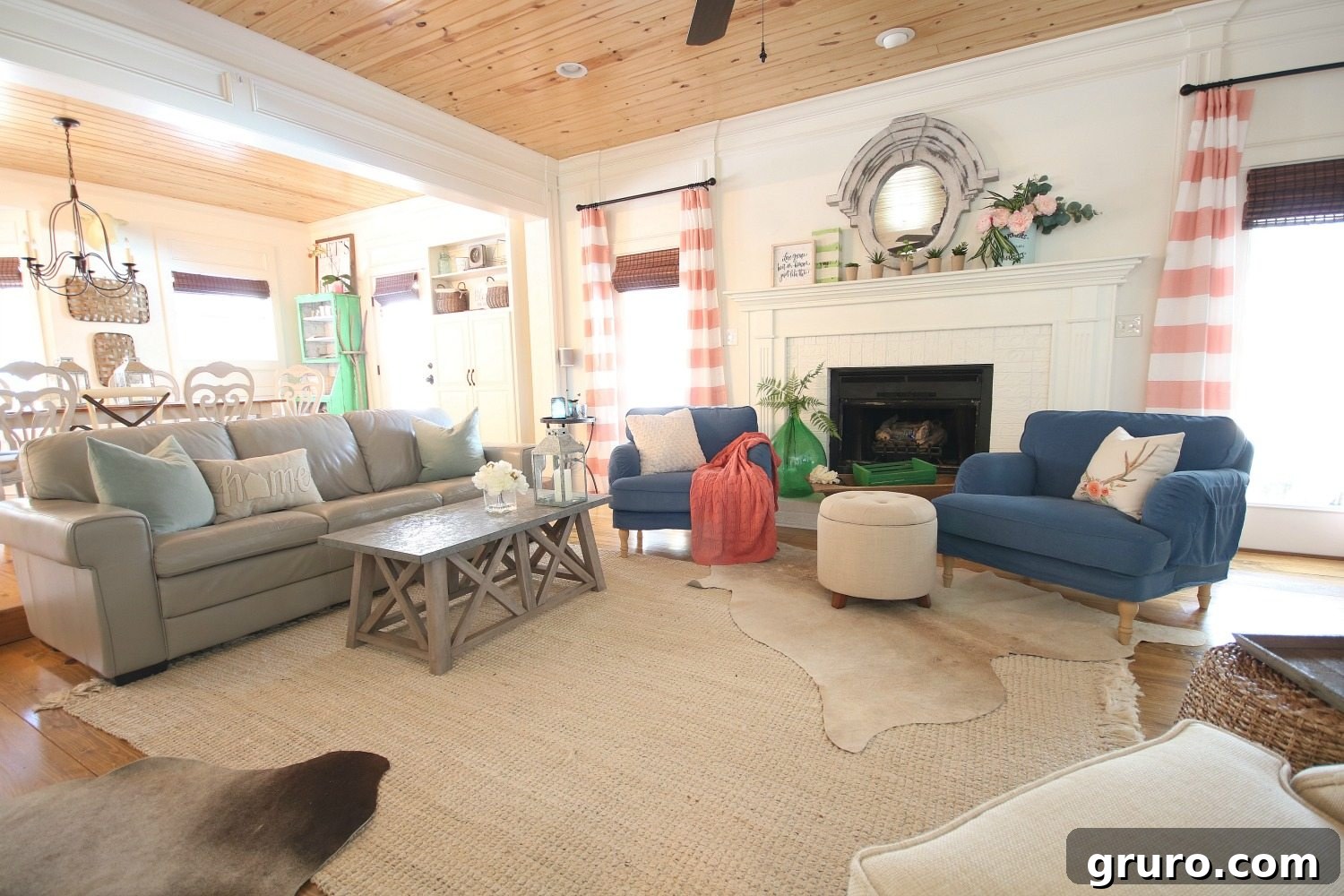 A captivating fireplace serves as the central focal point in a family room, beautifully accented with a harmonious blend of coral, blue, and green hues against a neutral backdrop. Sponsored by Better Homes & Gardens at Walmart.