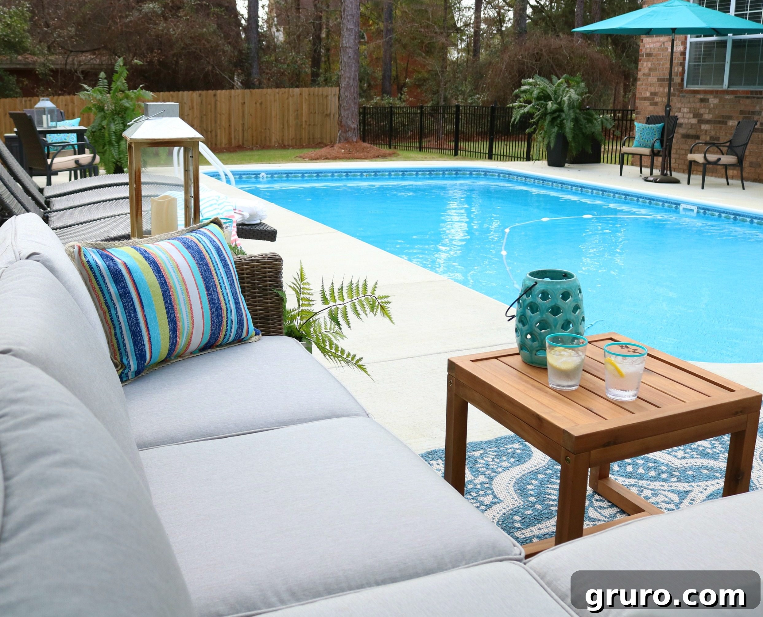 Outdoor rug with blue quatrefoil pattern, grounding the patio space.