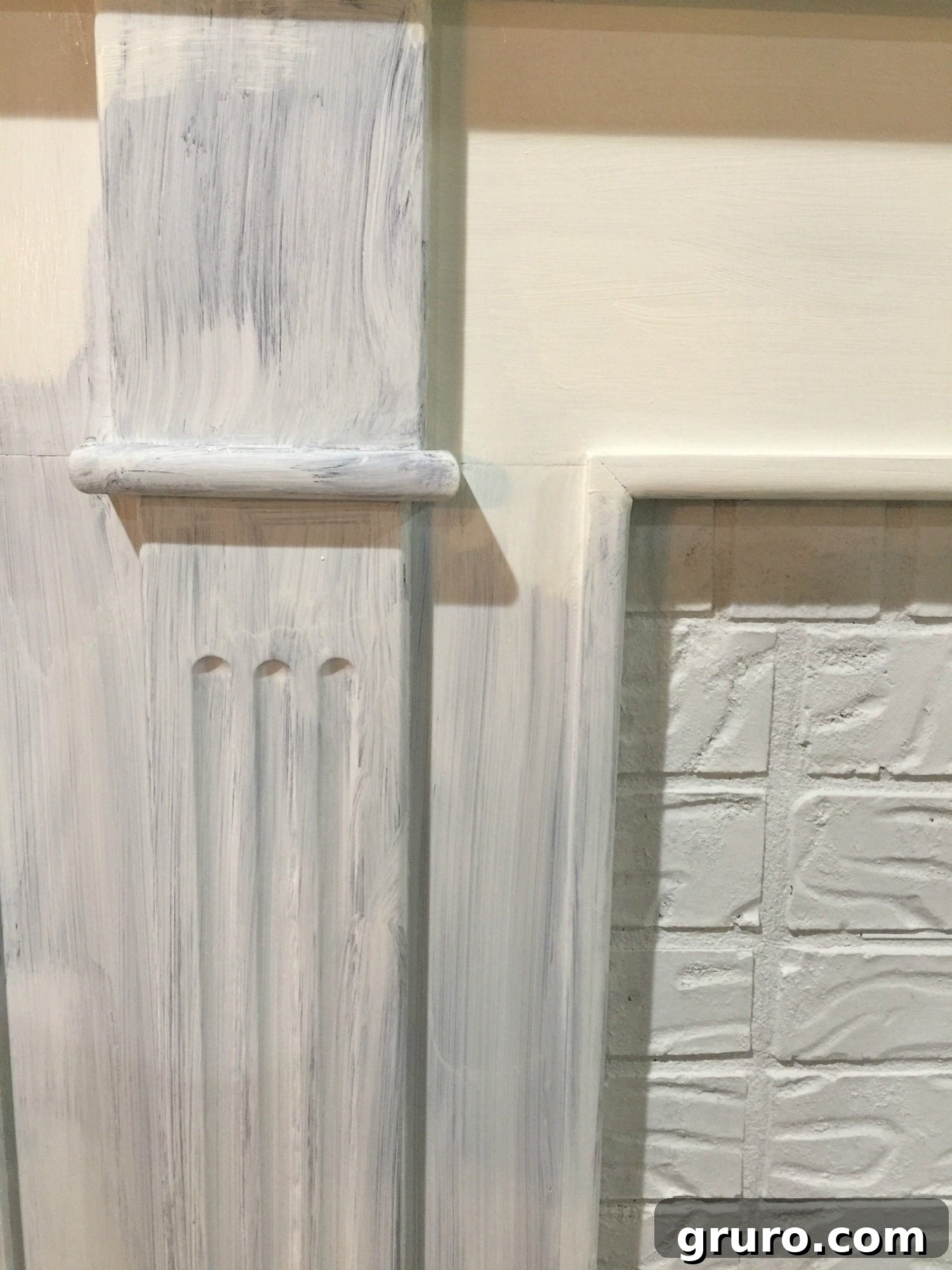 First Coat of Primer on Fireplace Brick and Wood Mantel