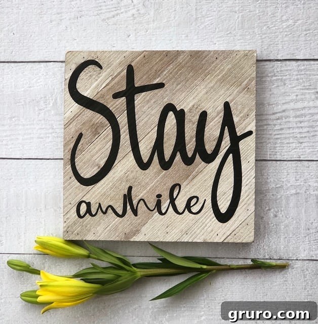 Applying Vinyl Design to the Wooden Sign DIY this Stay A While Sign - popular farmhouse sign. It's easy with a vinyl cutting machine.