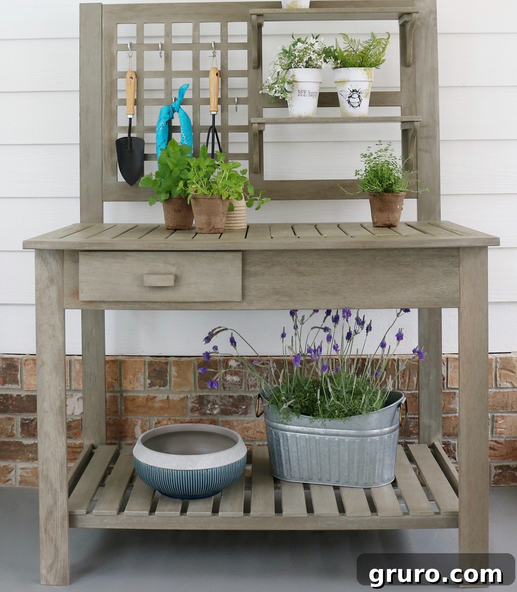 The Better Homes and Gardens Potting Bench showcasing its built-in bin and storage shelves in a neat outdoor setting.