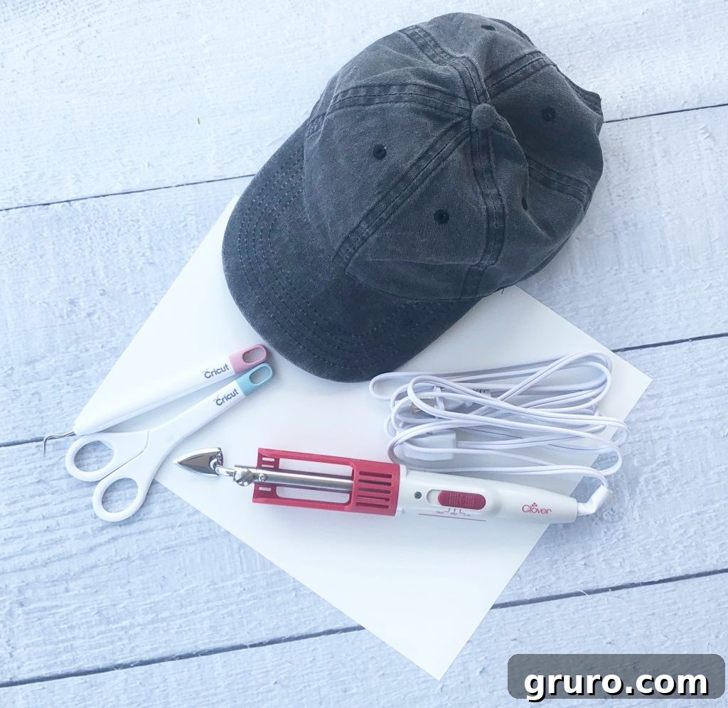 Cricut Project Supplies for Custom Cap Crafting supplies for DIY ball cap project, including heat transfer vinyl, weeding tools, and a blank cap.
