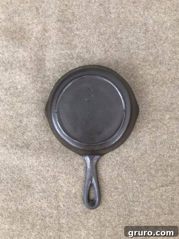 The clean and re-seasoned back of the cast iron skillet, demonstrating the successful restoration.