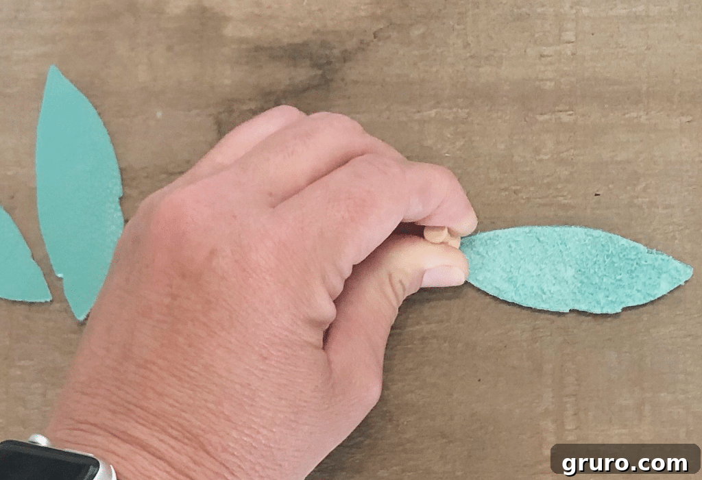 Creating Perfect Holes for Your Drop Earrings: How to Make Leather Feather Earrings with Cricut Method for punching holes in leather earrings for DIY assembly with Cricut.