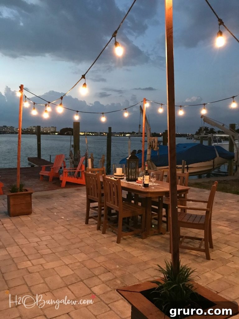 Beautiful outdoor cafe string lights strung between DIY poles, creating a warm evening atmosphere.