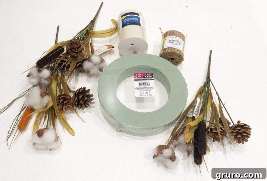 Collection of essential supplies for making a farmhouse candle ring: foam wreath form, burlap ribbon, sharp scissors, hot glue gun, faux floral stems with cotton and pinecones, wire cutters, floral pins, and a safe battery operated candle