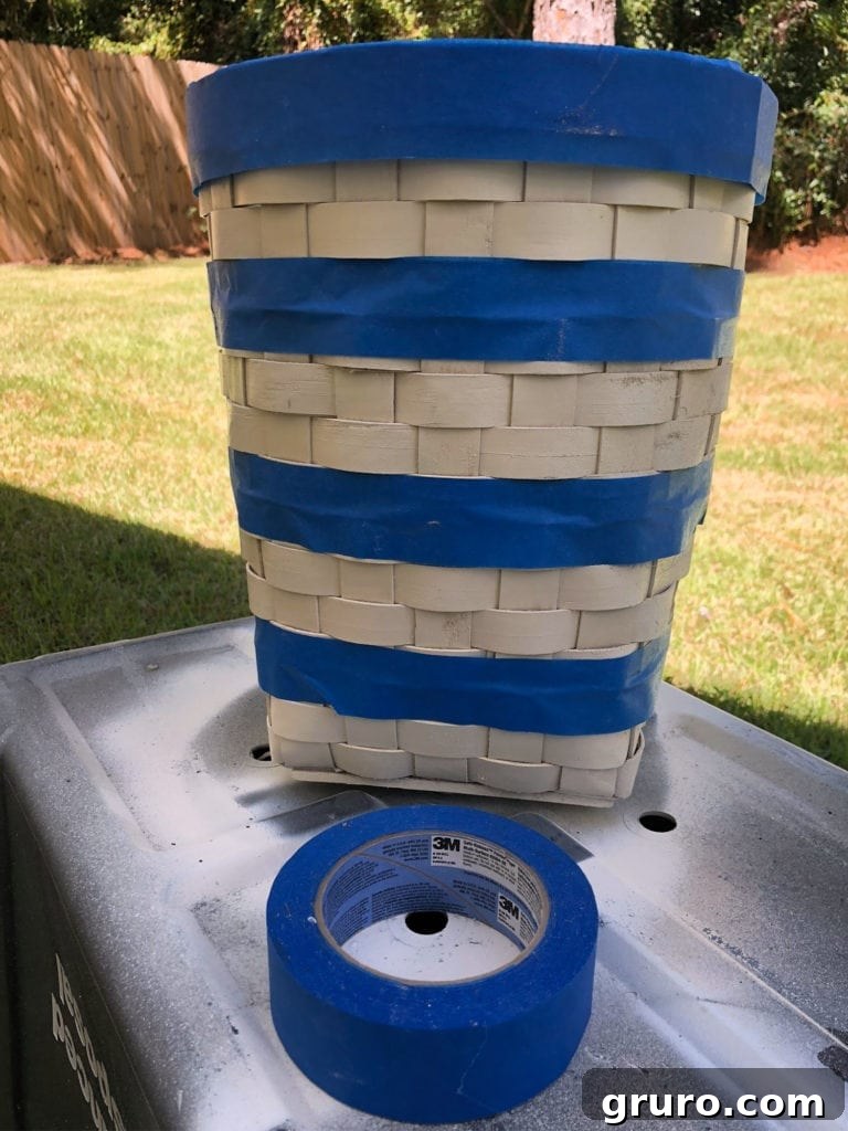 Guide: How to Paint Perfect Stripes on a Basket Applying painter's tape to a basket for painting stripes