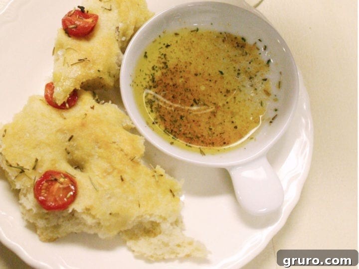 Freshly baked focaccia bread with cherry tomatoes and rosemary