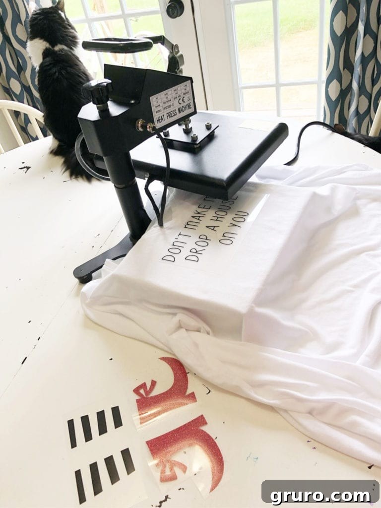 Heat Press Halloween T-Shirt Vinyl Idea Halloween T-shirt with witch legs design positioned on a heat press, ready for transfer