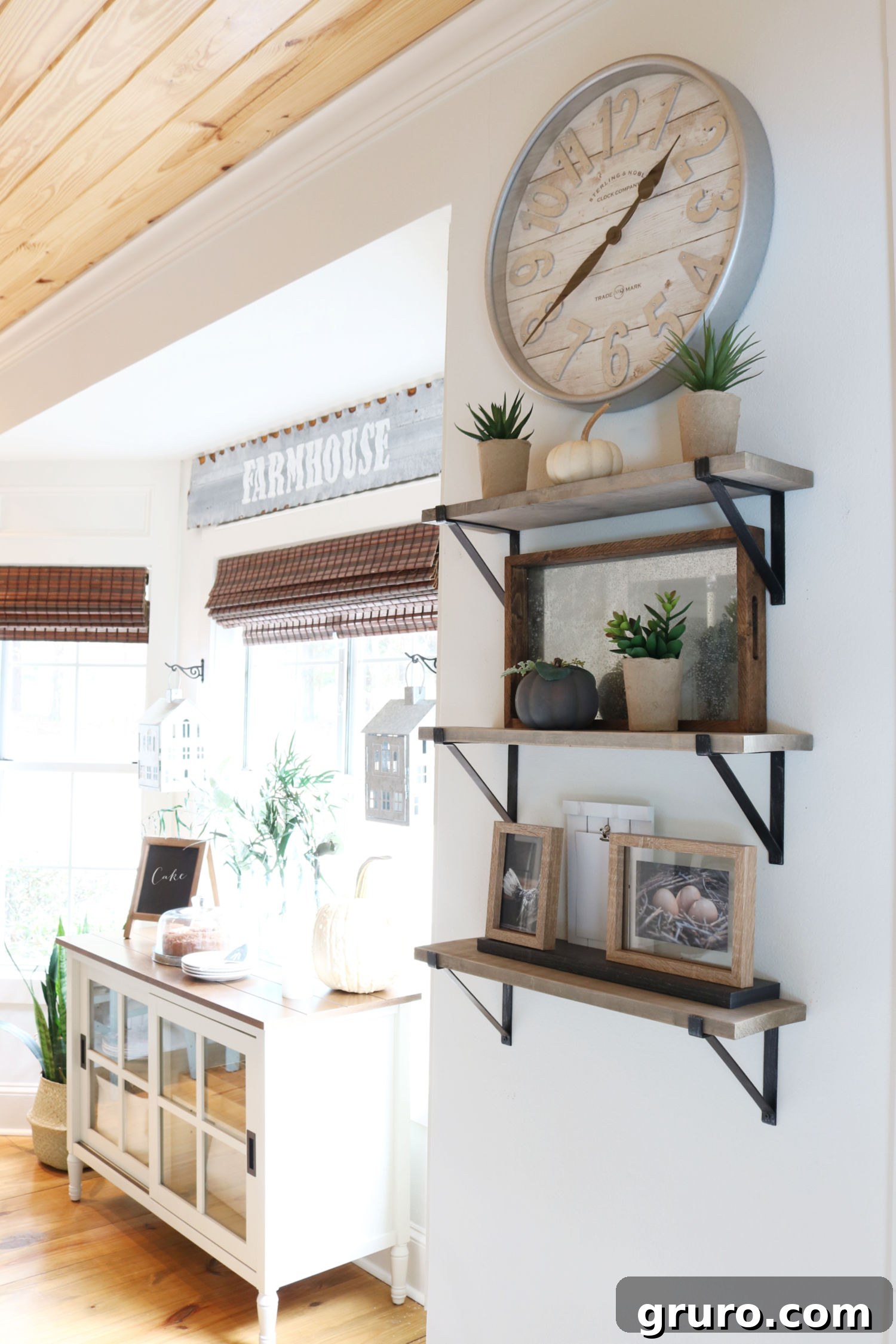 Farmhouse decor with rustic wood shelves and a striking galvanized clock Close-up of styled farmhouse shelves featuring wood and metal galvanized clock decor