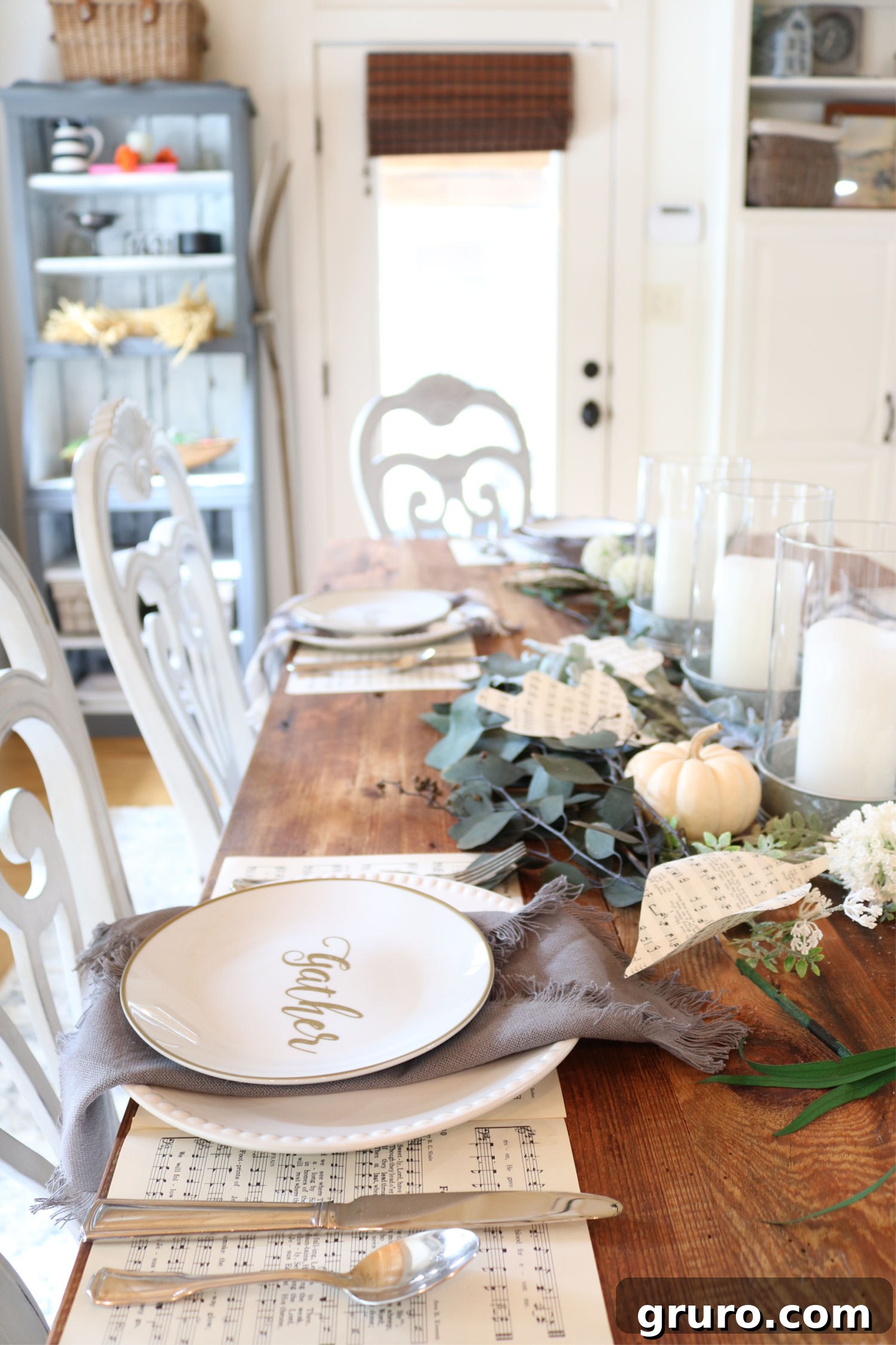 Barn wood table elegantly decorated with a farmhouse place setting for fall Beautiful farmhouse place setting on a barn wood table, ready for fall entertaining