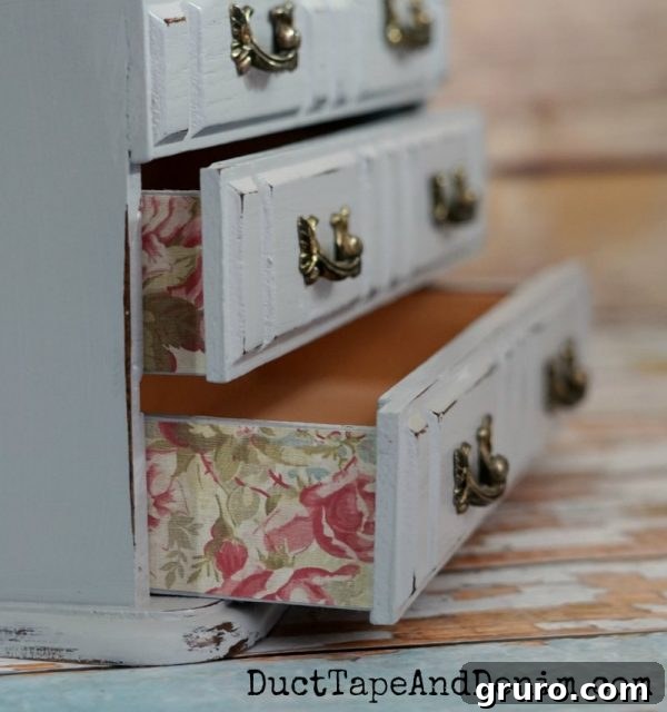 Close-up of floral scrapbook paper on sides of drawers of a jewelry box