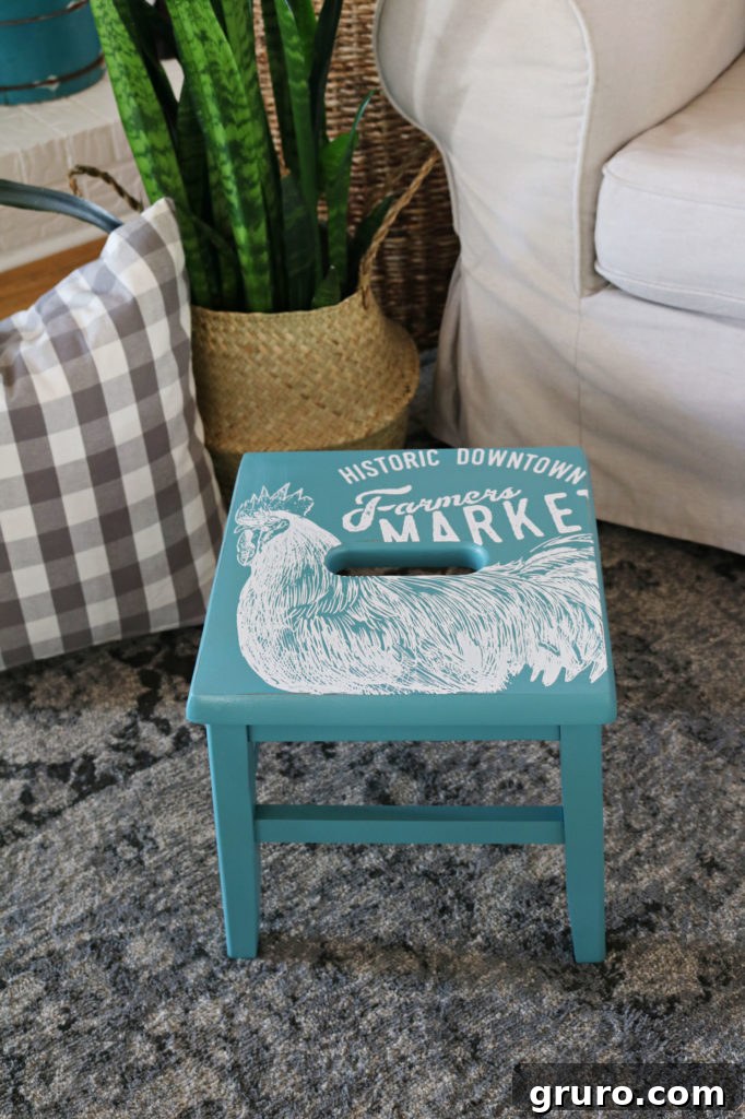Wooden Step Stool Reimagined 11 The completed wooden farmhouse-style step stool with its fresh paint and charming stencil design, looking stylish.