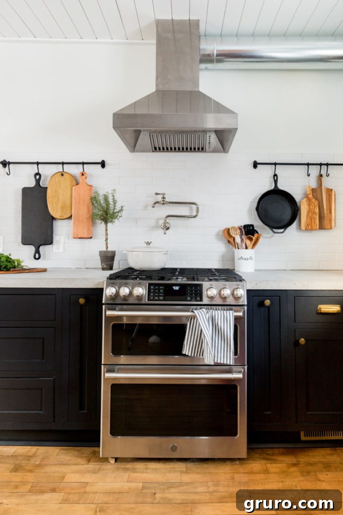 Modern Rustic Kitchen Makeover featuring contrasting light and dark elements with wooden beams and white cabinets