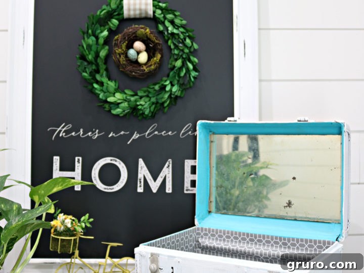 Finished DIY vintage train case makeover, showcasing its new look