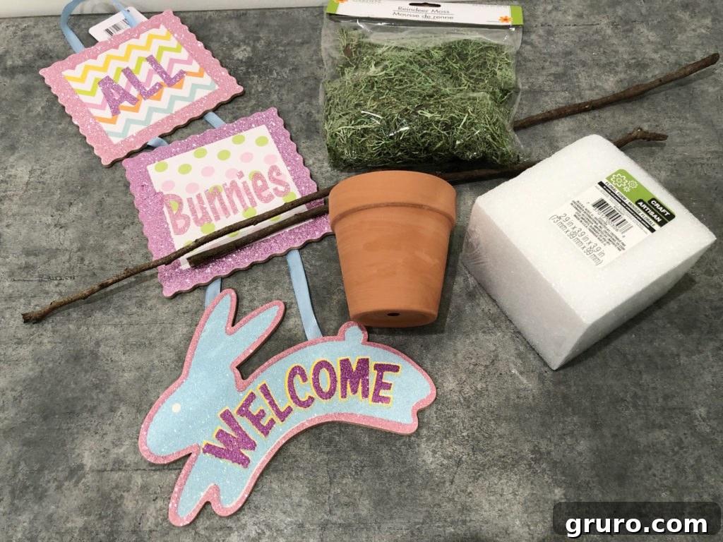 Dollar Store Bunny Topiary Supplies Assorted dollar store items for making a DIY bunny topiary, including pots, bunny signs, and moss