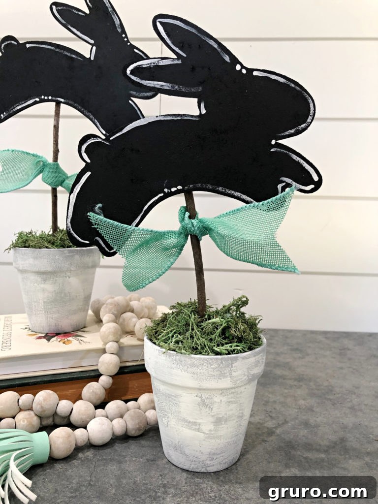 Easy DIY Bunny Topiaries Finished easy to make bunny topiaries displayed as charming Easter decorations