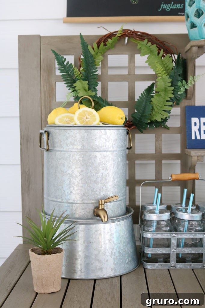 A galvanized drink holder with fruit infuser, ideal for outdoor refreshments.