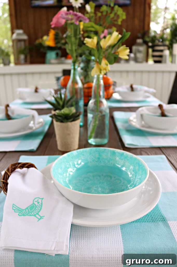 Melamine white dishes paired with a vibrant teal bowl, ready for outdoor dining.