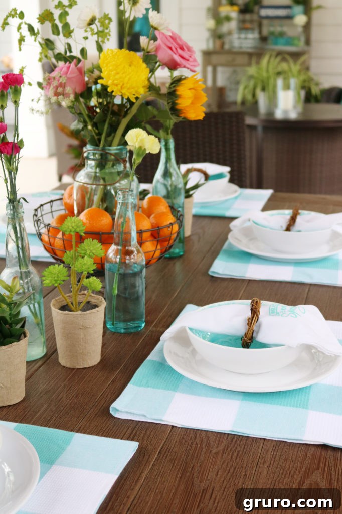 Charming outdoor dining table set with affordable farmhouse-inspired decor and teal accents.