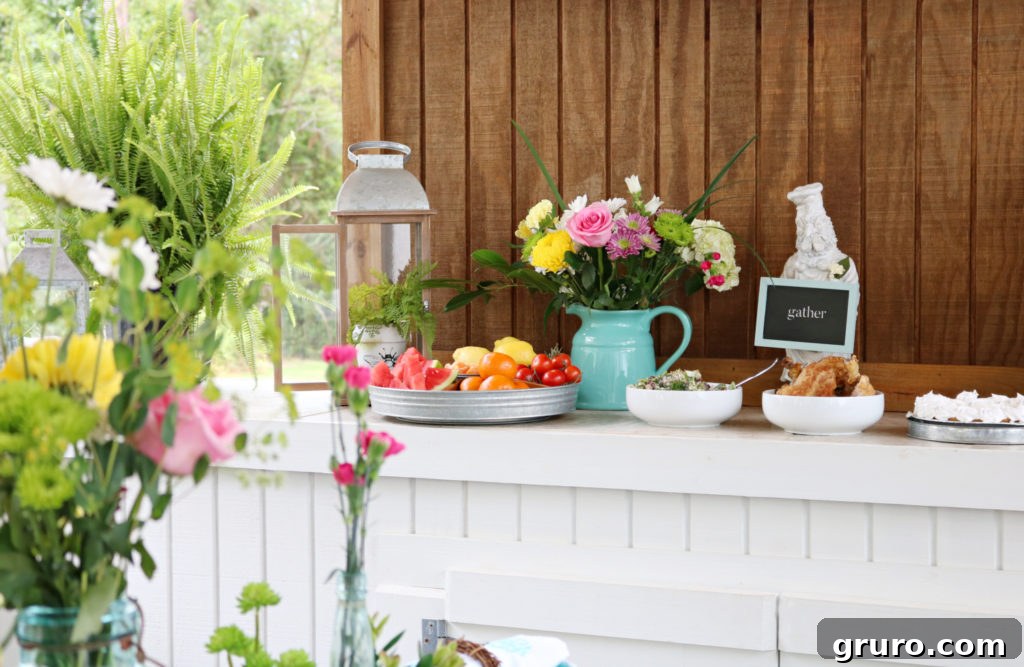 A spacious farmhouse table set for a large gathering on a back porch, ready for buffet dining.