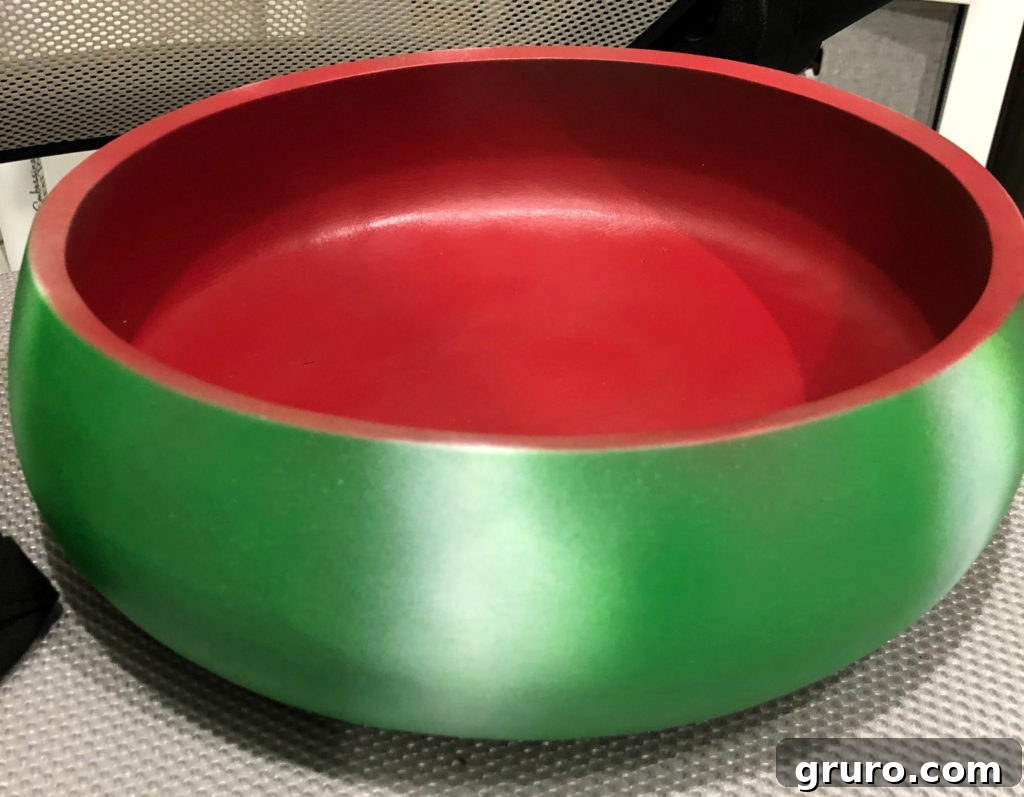 Red interior of vintage wood bowl being spray painted