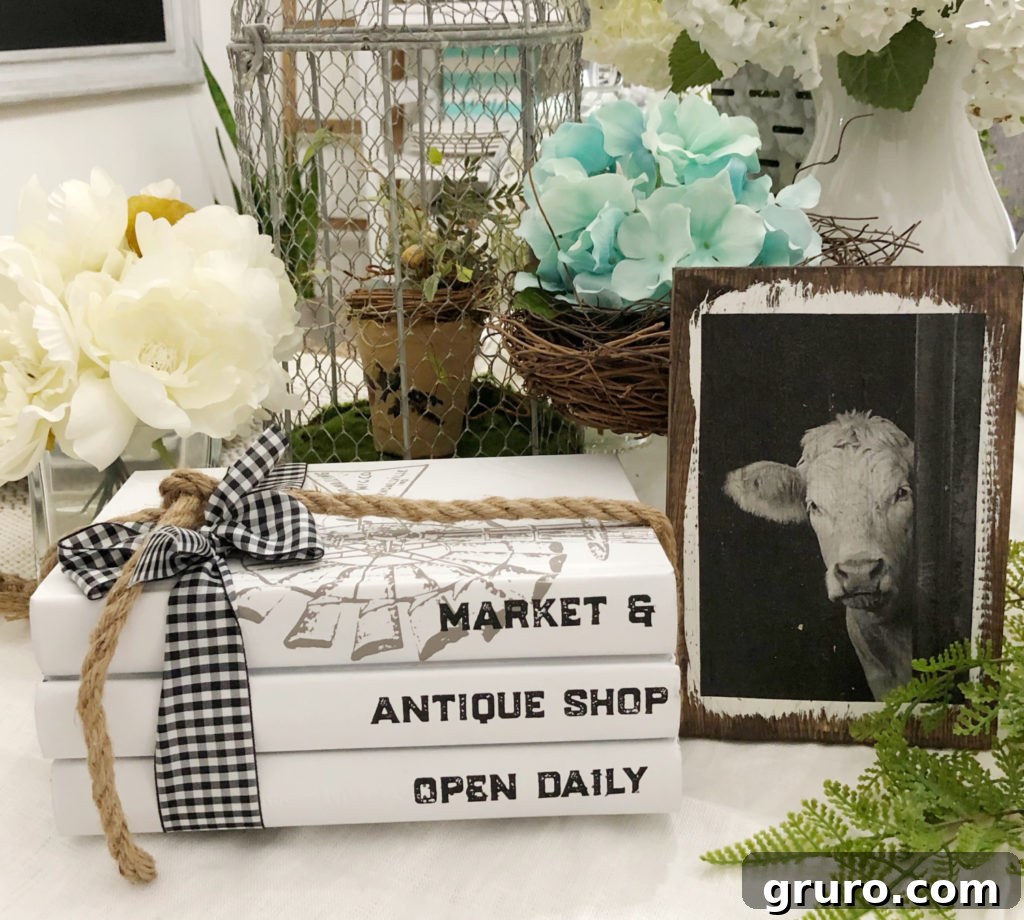 Close-up of DIY white painted book stacks with rustic accents