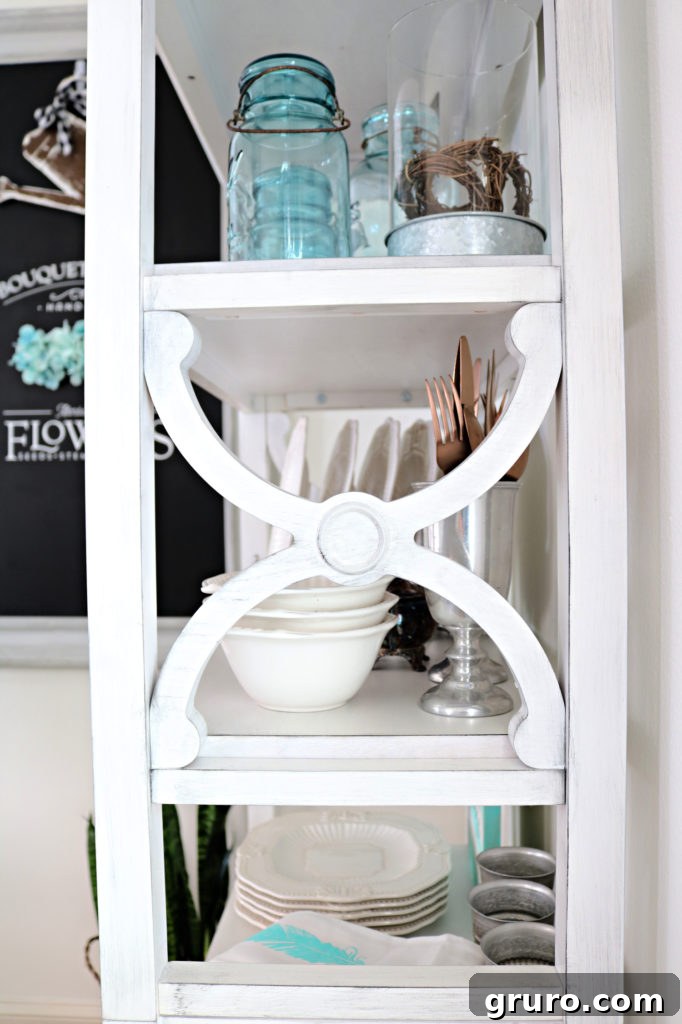 Curated Dining Room Shelving 8 white bookcase styled with dining essentials and decorative items.