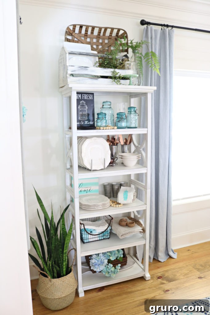 Curated Dining Room Shelving 10 white open shelves filled with elegant dishes and decor.