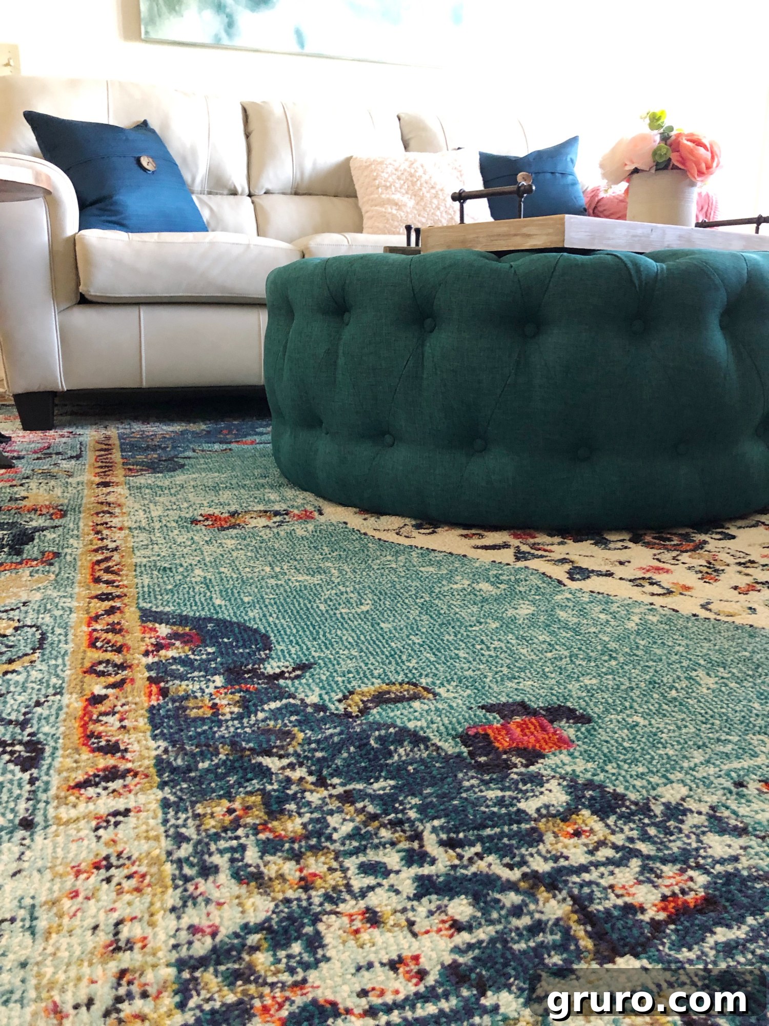 Murphy the dog enjoying the comfortable teal accents and soft rug in the newly decorated lake condo living room.