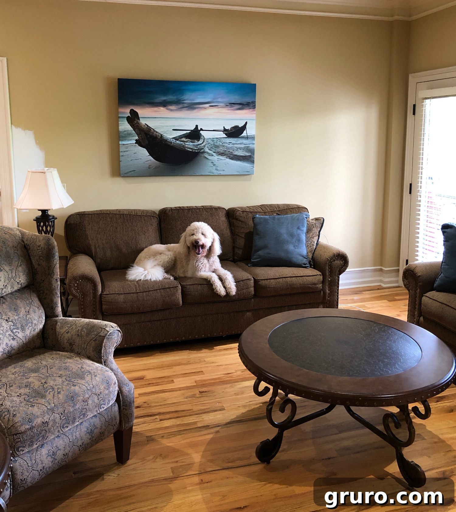 Before image of a lake condo living room, showcasing its dark and dated appearance before the vibrant teal decor makeover.