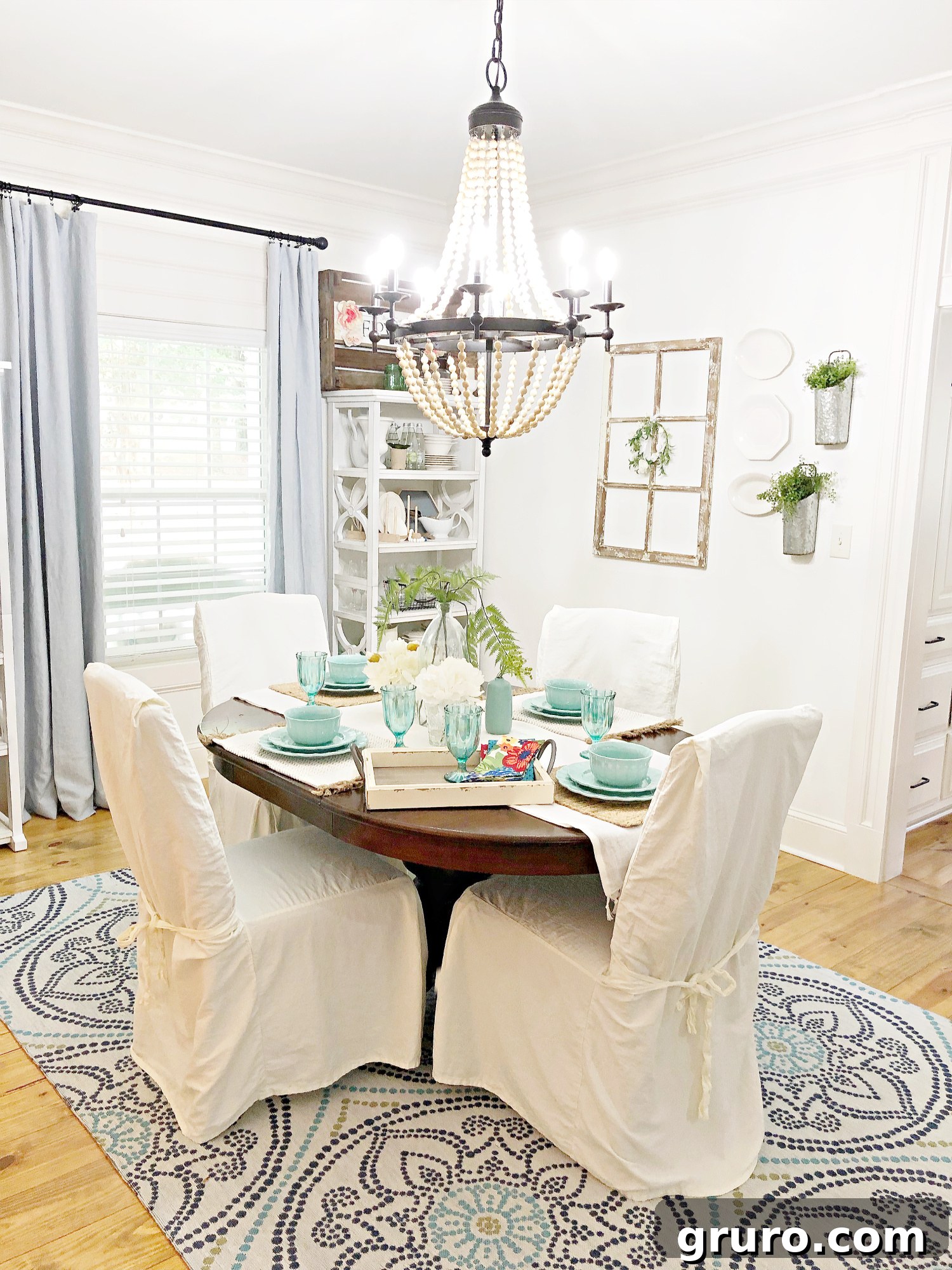 An inspiring vintage farmhouse dining room idea, showcasing a complete and harmoniously styled table setting with charming decor elements, perfect for gathering.