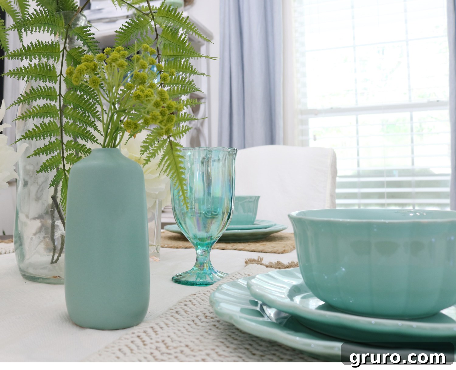 A charming small bud vase featuring a delicate floral arrangement, serving as a simple yet effective centerpiece, adding natural beauty to a vintage dining room setup.