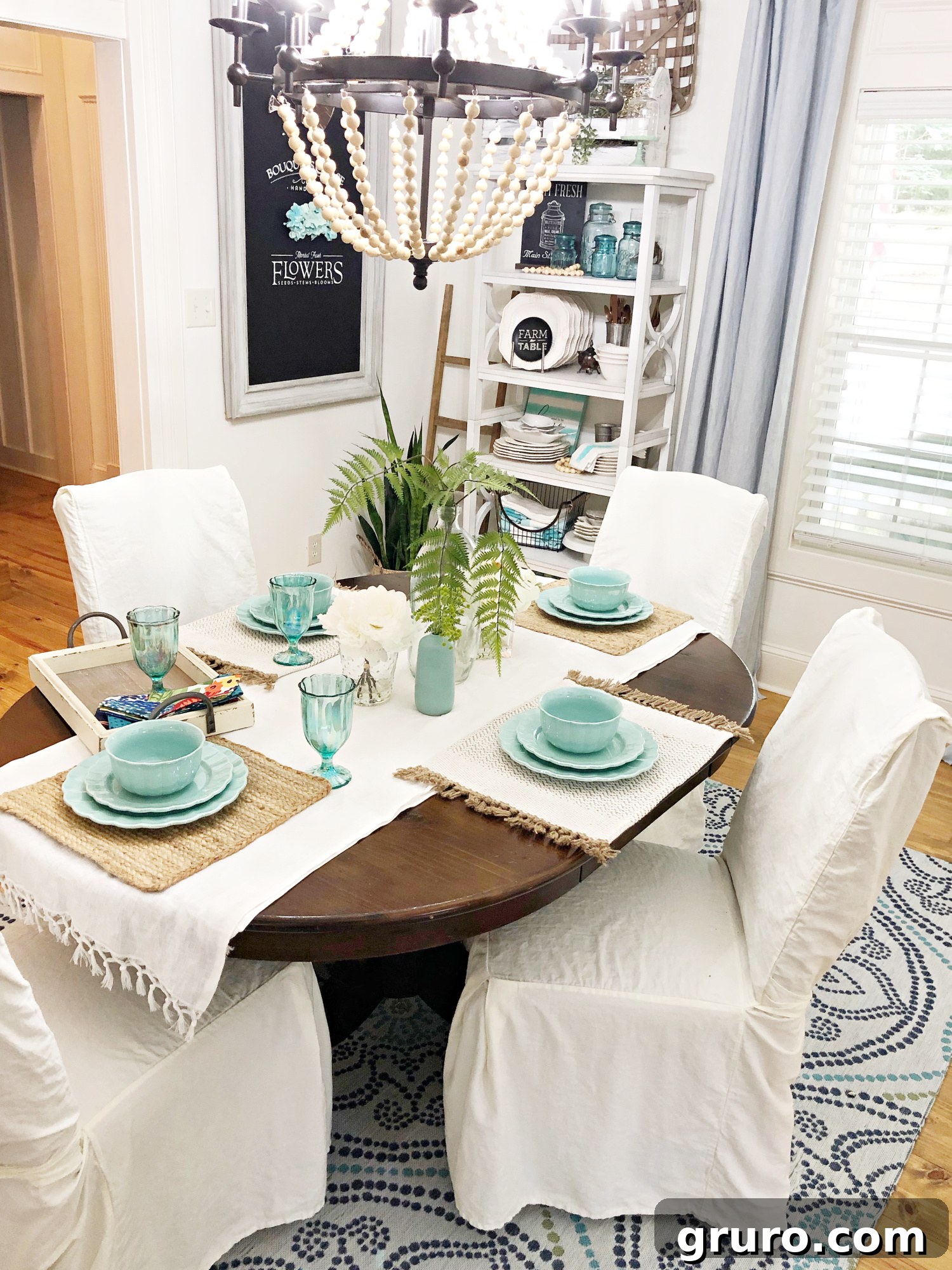 A wide shot of the refreshed vintage farmhouse dining room, showcasing the brightened ambiance, the inviting table setting, and the harmonious blend of decor elements.