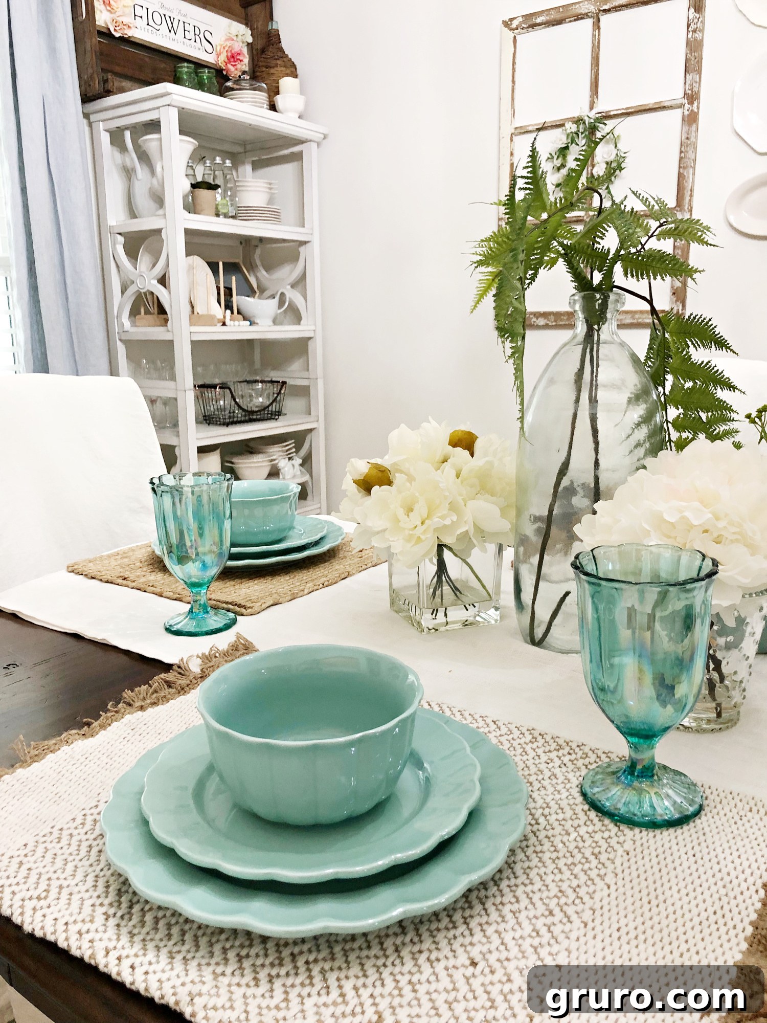 A meticulously arranged vintage farmhouse table setting, highlighting the interplay of vibrant colors, varied textures, and carefully chosen details to create a cohesive and inviting aesthetic.