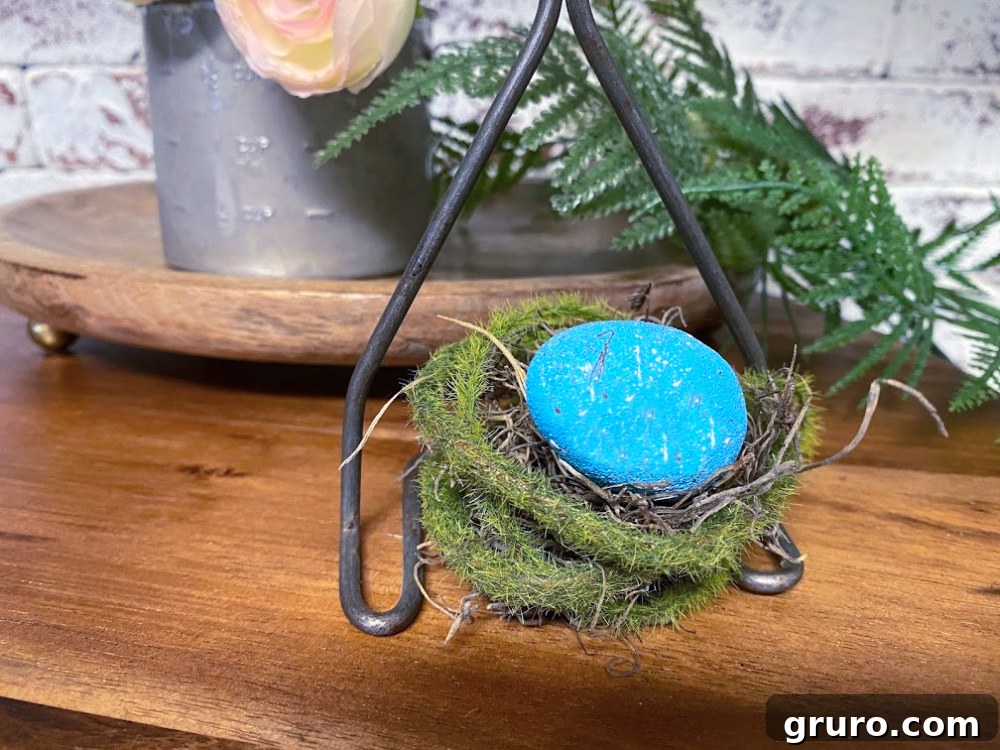 Decorative bird's nest nestled within an antique kitchen utensil