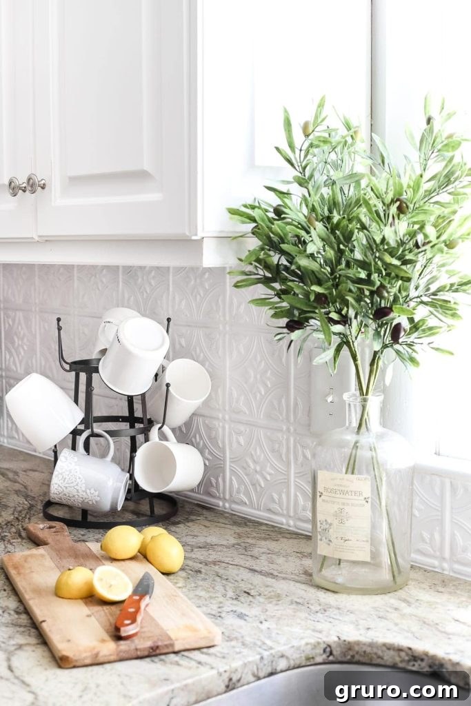 Elevating White Kitchens: 30 Backsplash Inspirations 19 Pressed Tin Backsplash in White
