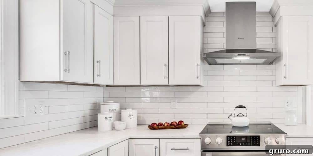 Elevating White Kitchens: 30 Backsplash Inspirations 5 Wide White Subway Tile Backsplash for White Cabinets