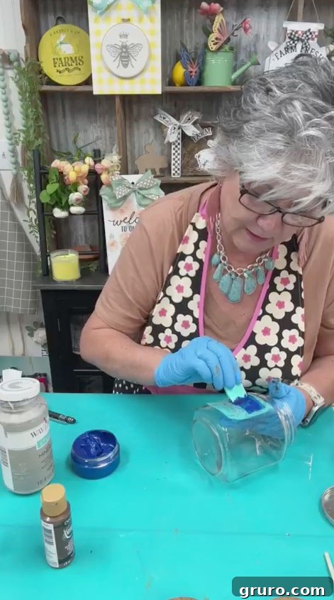 Application of glass etching cream over a Chalk Couture transfer on a mason jar