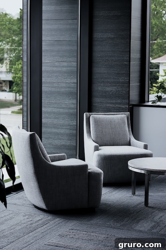 Modern home office with dark furniture and a large window.
